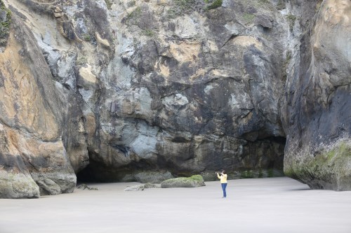 This steep sided cove is really cool. Those are two sea caves behind Lisa. At low tide there is plenty of space here, but at high tide the water comes up into this cove area, continuing to erode the caves further.